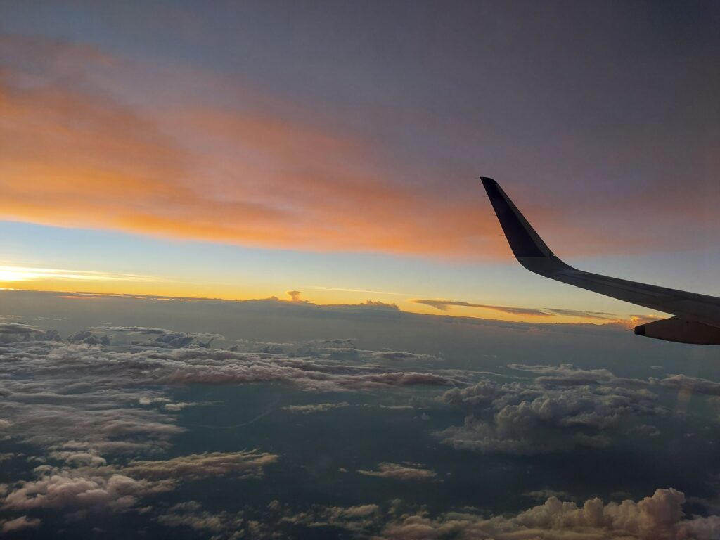 Sunset above the clouds, seen from an aircraft window