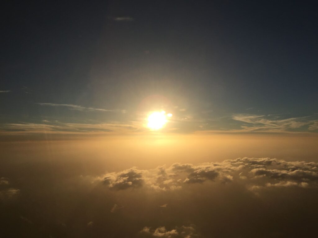 The sun setting above the clouds, seen from an aircraft over Texas, USA